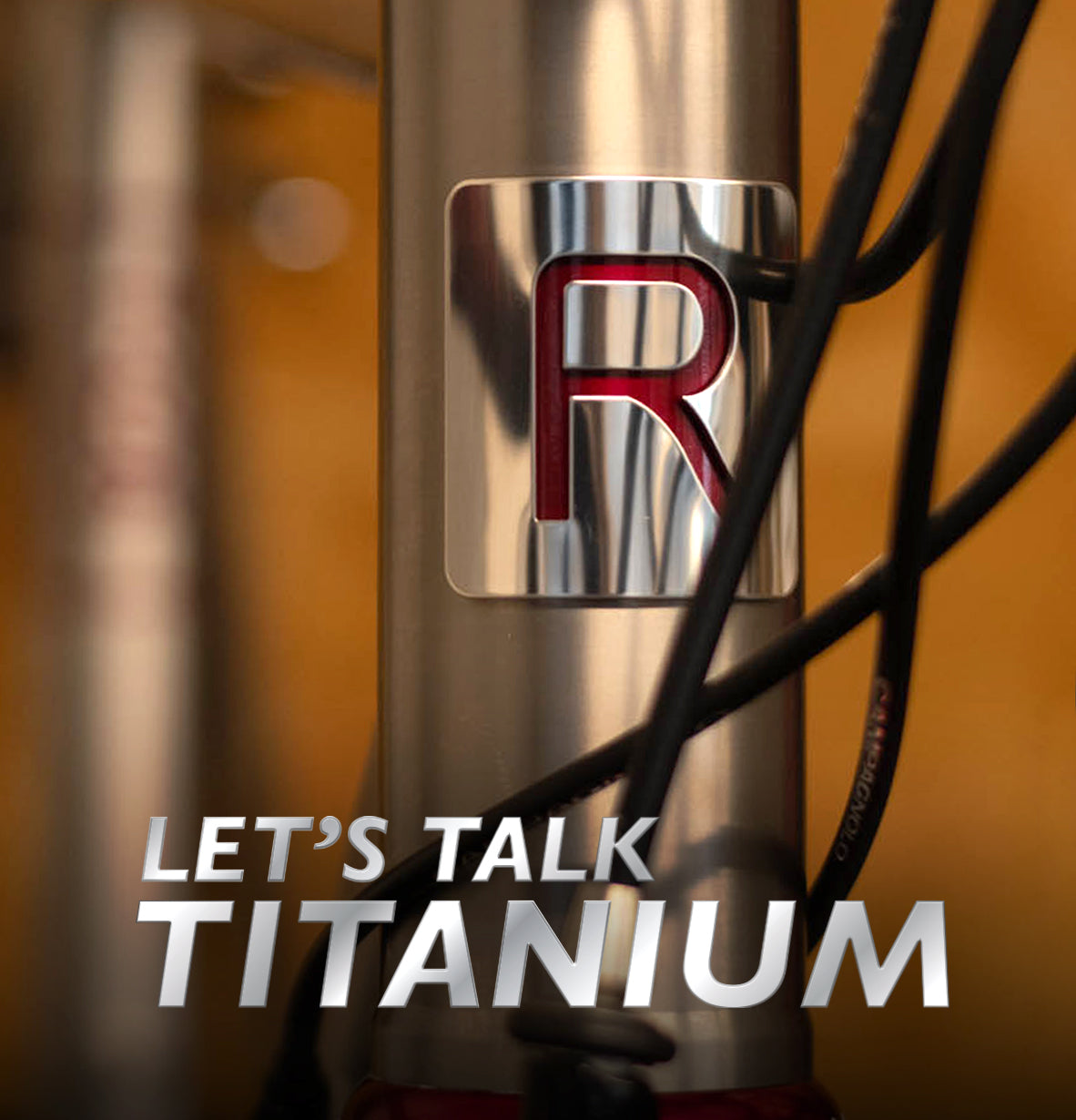 Reilly headbadge in brushed silver and red with the wording Let's Talk Titanium.