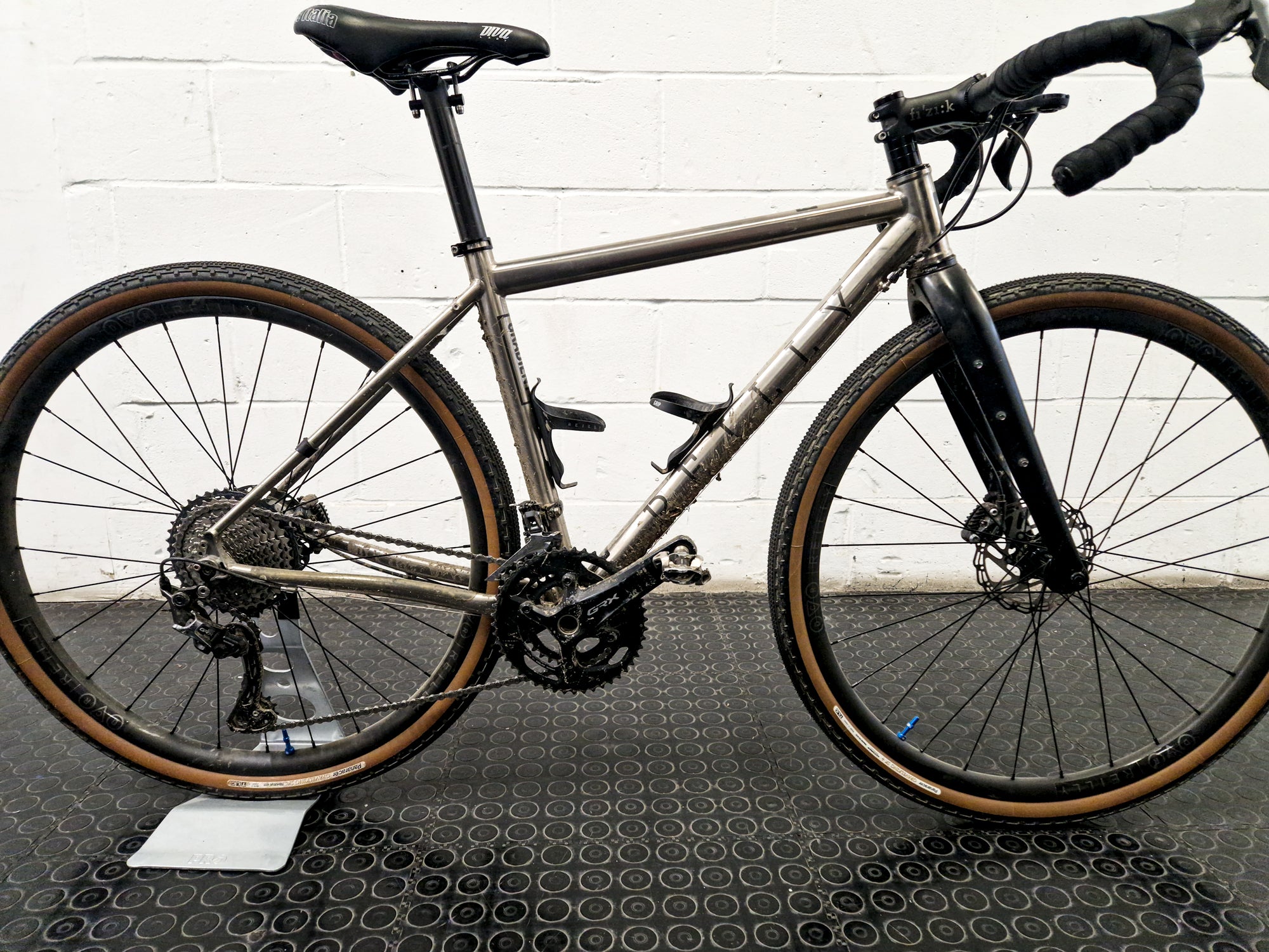 A dirty bike with an old chain.