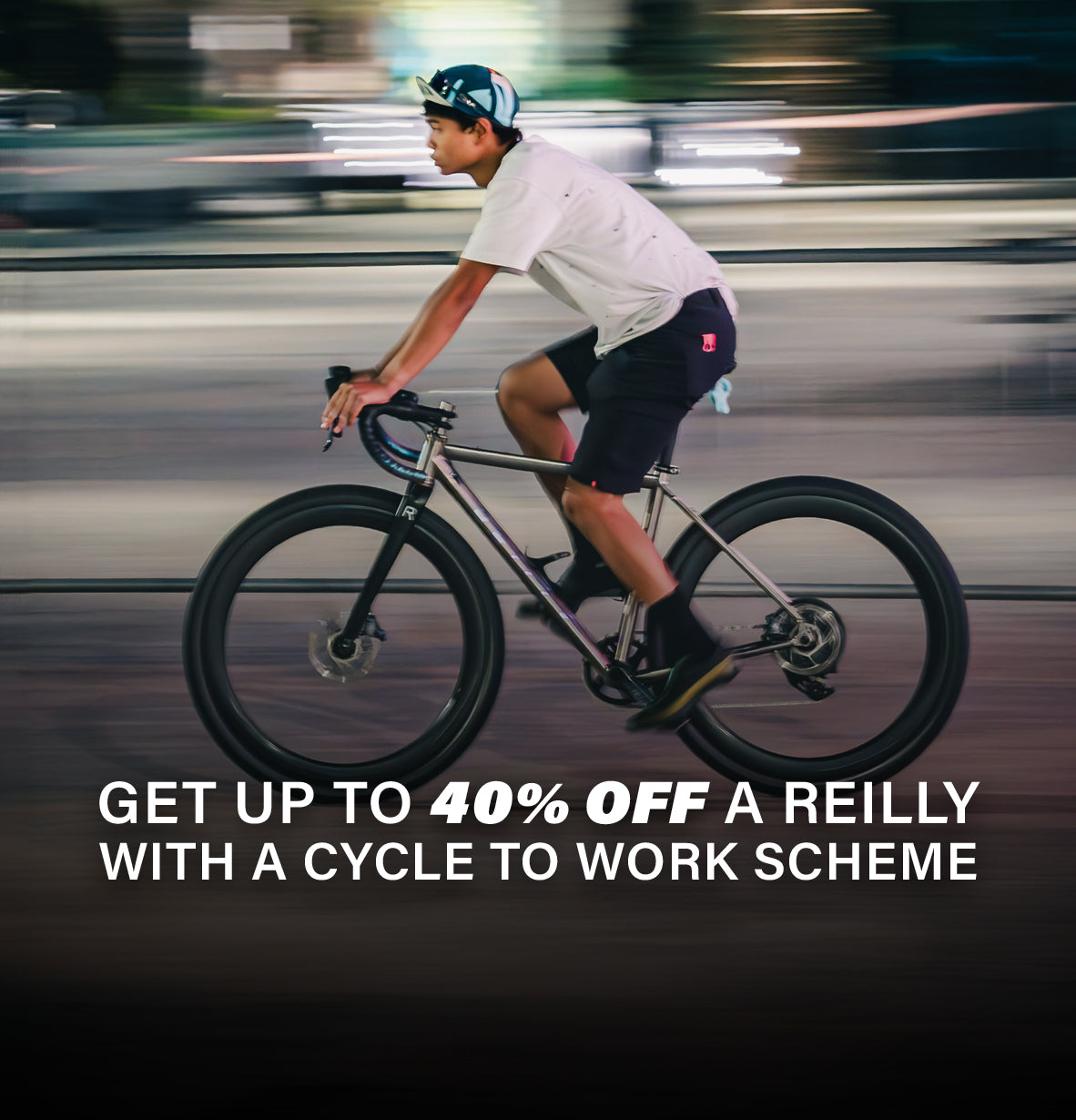 Man in Tshirt and shorts on a titanium bike.  Urban background is blurred. Wording is Get 40% off a Reilly with a Cycle to work Scheme.  
