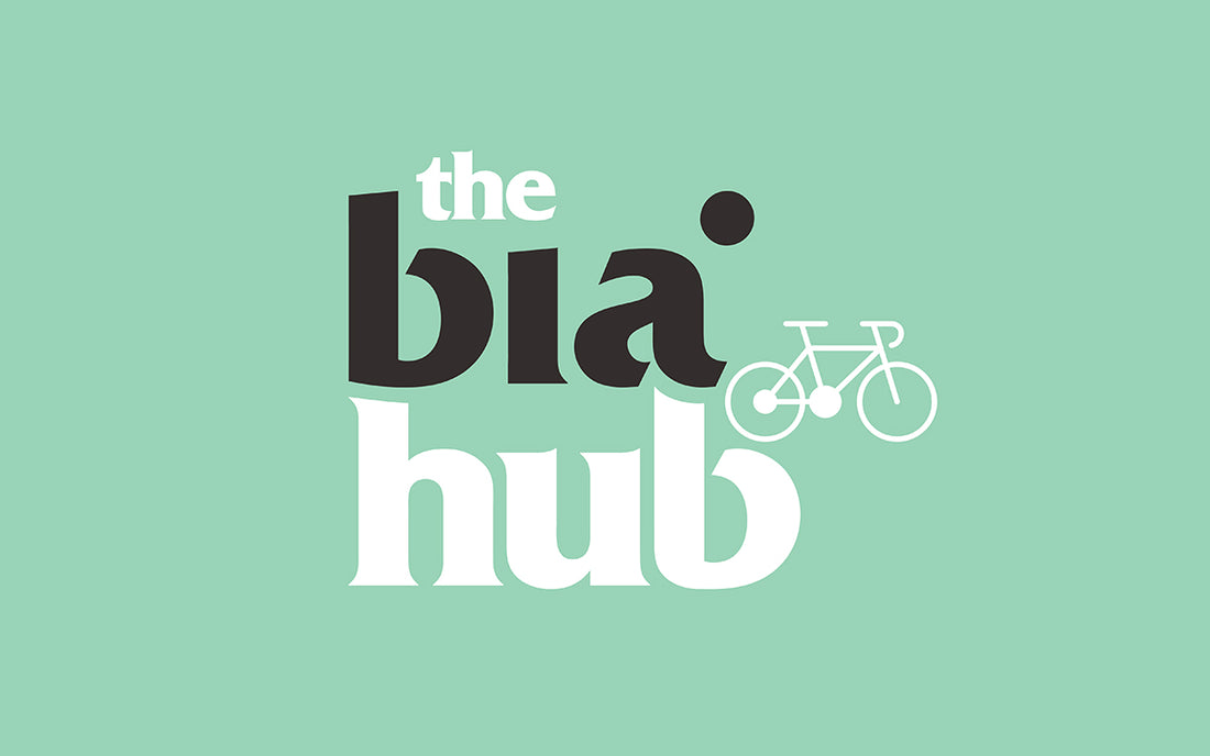 On distinctive turquoise background the works the bia hub and a drawing of a bike.