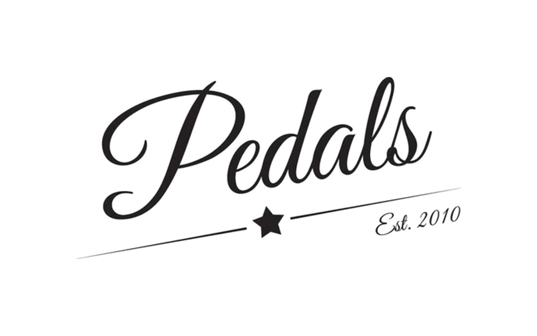 Pedals written in handwriting font with a star and est. 2010 underneath