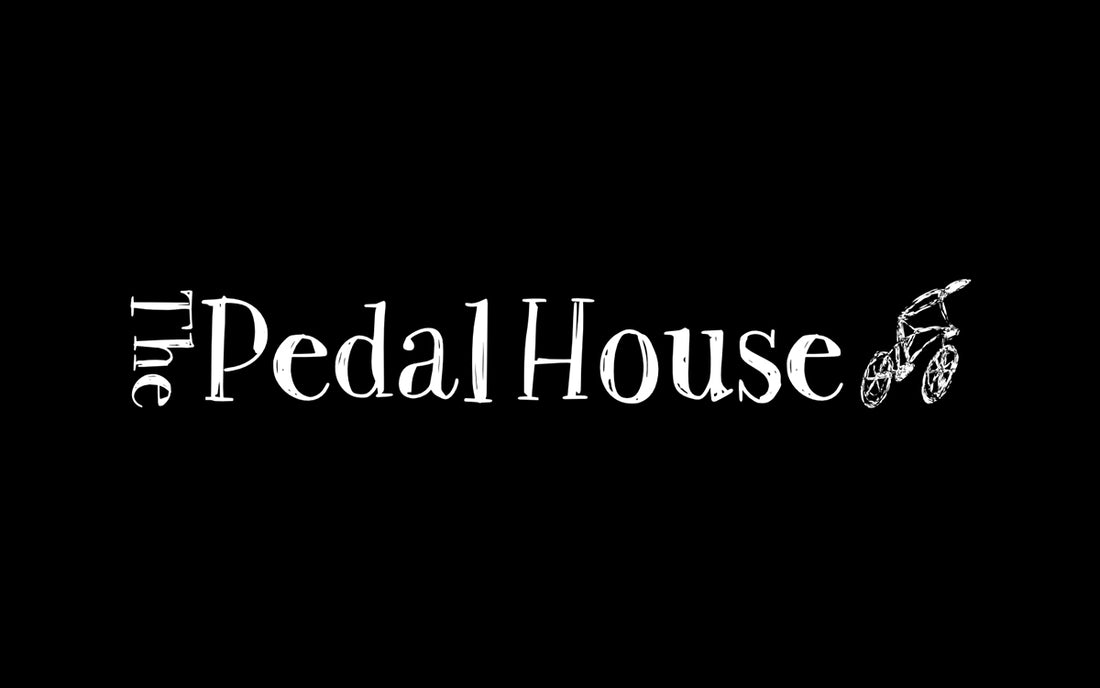 The Pedal House with a line drawing of a person riding a bike on black background. 