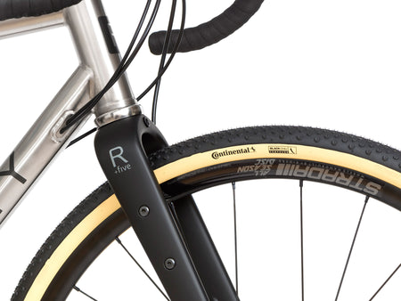 close up of side of a Reilly carbon adventure fork on a bike 