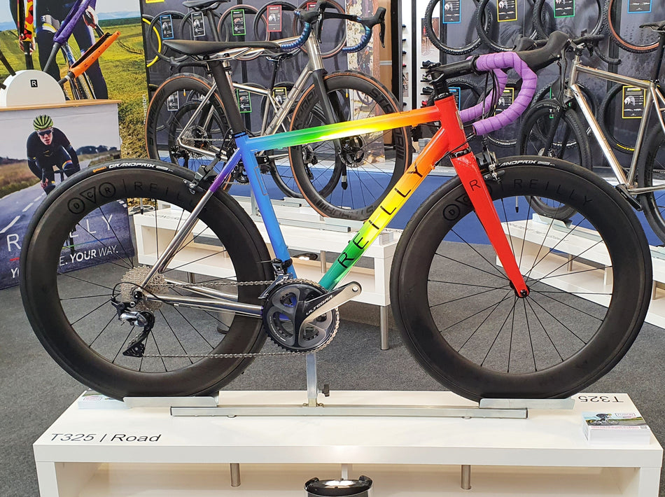 The Rainbow Warrior, a T325 with painted frame in rainbow colours.  Featuring purple bar tap and DCR x Reilly wheelset.