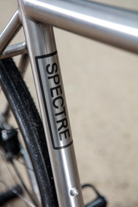 Close up of Spectre decal in black on seat tube.