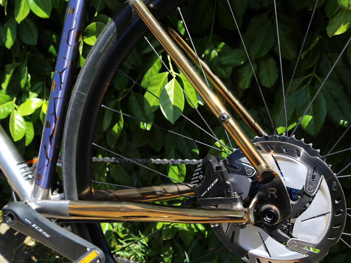 Gold anodised stays with disc brake.  Blue anodised seat tube with decorative pattern is also in shot.